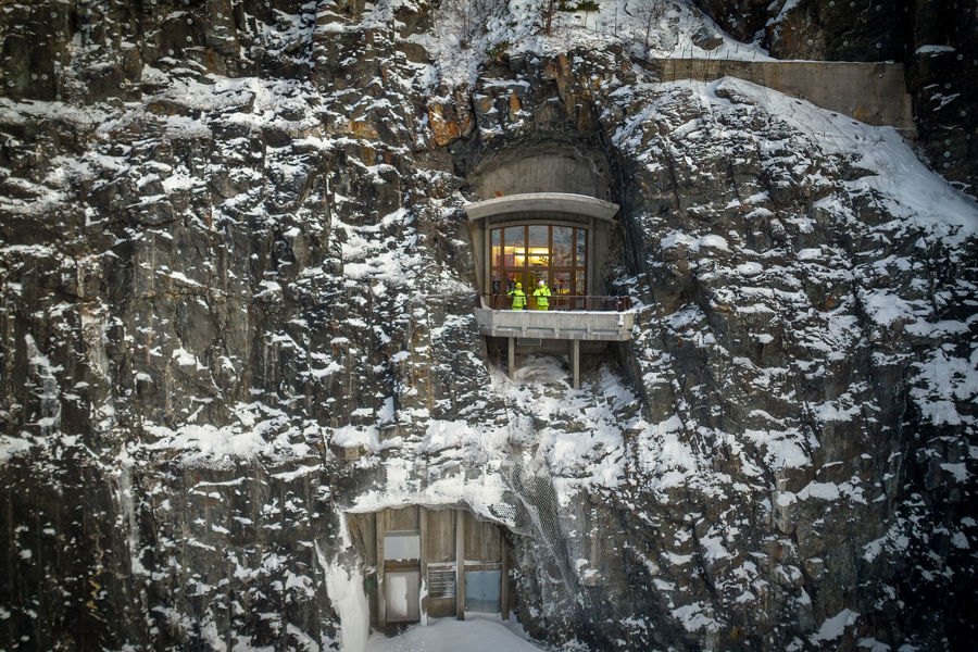 To ansatte står ved inngangen til vannkraftverket i fjellet