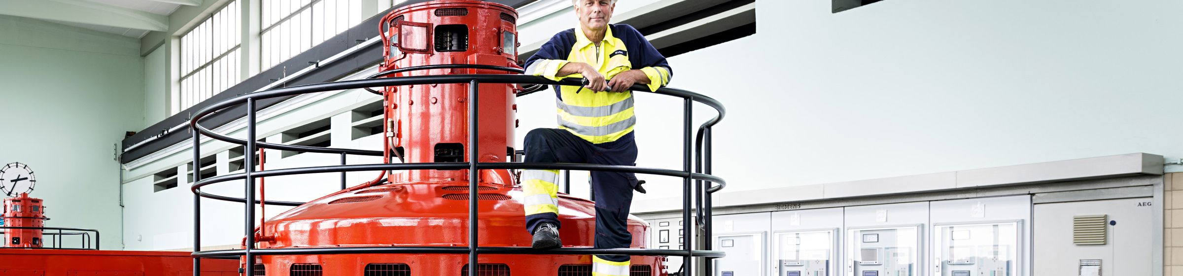 Mann står i maskinhallen på et vannkraftverk