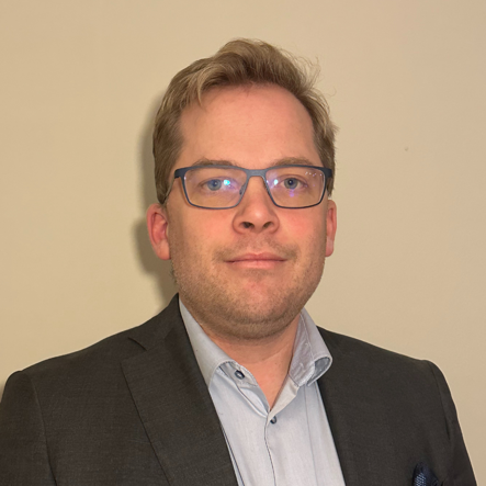 Man with glasses looking into the camera